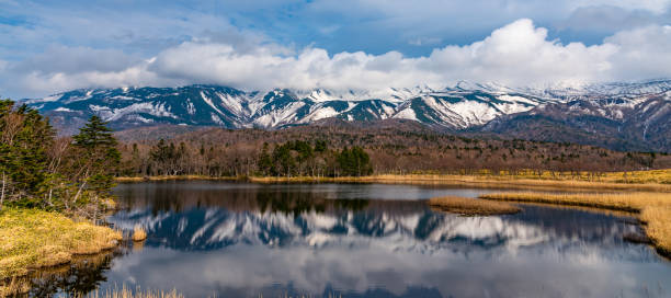 The First Lake of Shiretoko Goko Five Lakes, Shiretoko National Park The First Lake of Shiretoko Goko Five Lakes, Shiretoko National Park. Natural beauty scenery, mountain range and woodland in high latitude country springtime sunny day. Hokkaido, Japan shiretoko mountains stock pictures, royalty-free photos & images