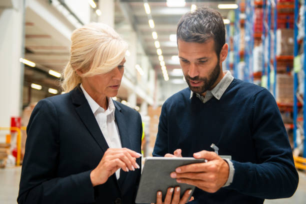 istock Managers in Warehouse discuss about business strategy 1210740938