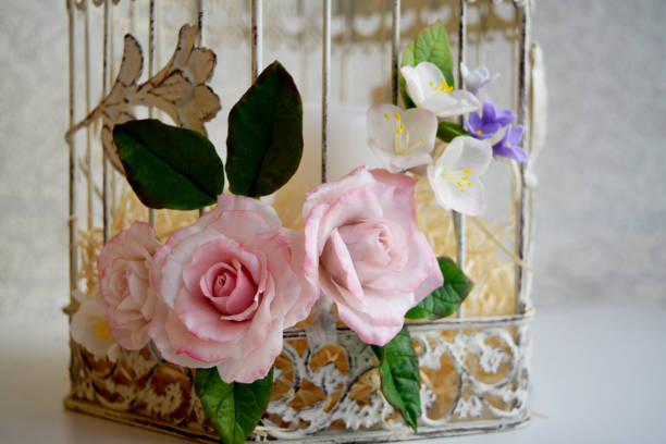 istock Bird cage with spring blossom flowers. Wedding decorations. 1210741525