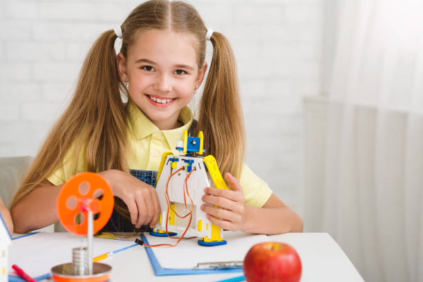 istock Innovation concept. Girl showing her robot, copy space 1210742464