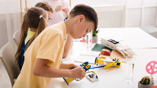 istock Robotic education. Smart teen boy constructing diy robot 1210742544