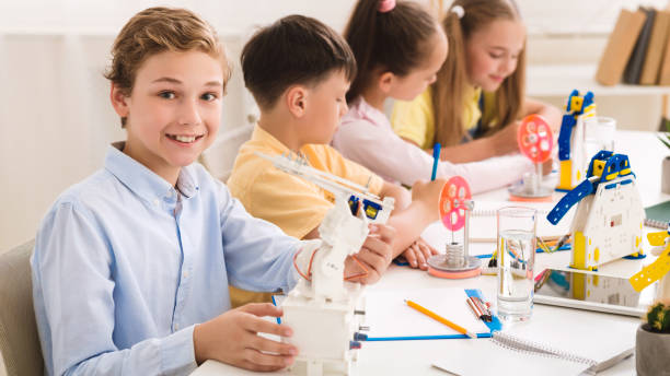 istock Innovation concept. Smart boy showing his robot 1210742561