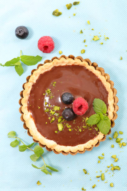 istock chocolate tart with berry fruit- top view 1210742915