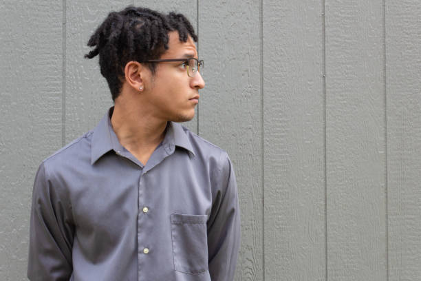 istock Mixed race millennial man, profile view in glasses looking up, neutral background copy space with light texture 1210745327