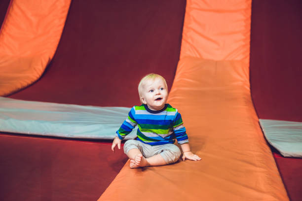 istock Cute little boy on a trampoline in a trampoline center 1210745334