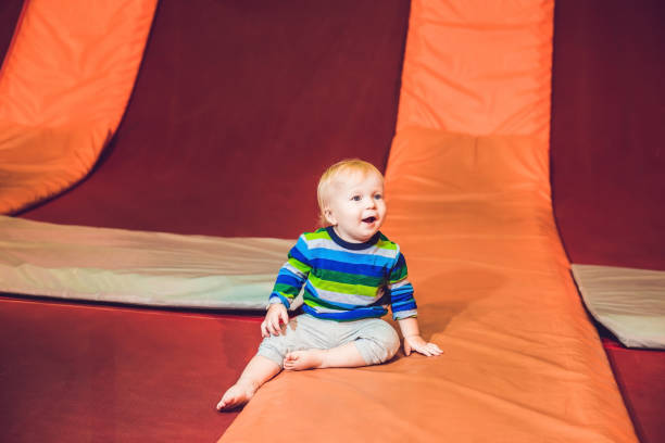 istock Cute little boy on a trampoline in a trampoline center 1210745335