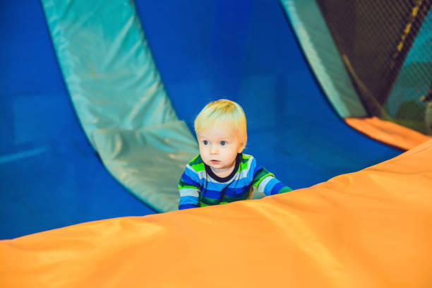 istock Cute little boy on a trampoline in a trampoline center 1210745441