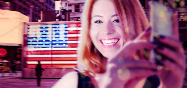 happy young woman taking selfie in Time square