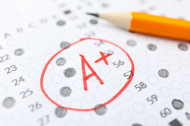 istock Test score sheet with answers, grade A+ and pencil, close up 1210746712