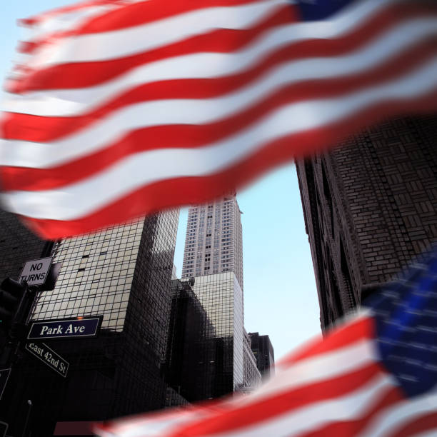 istock Low angle Manhattan view with American flag 1210746754