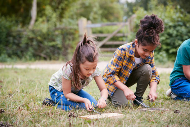 istock Two Girls On Outdoor Camping Trip Learning How To Make Fire 1210747603