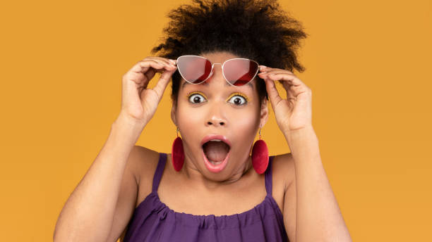 istock Surprised black woman screaming looking at camera 1210748542