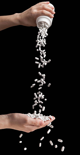 Spilling vitamin pills stock photo