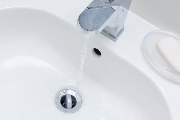 istock Modern bathroom sink in white home interior 1210750006