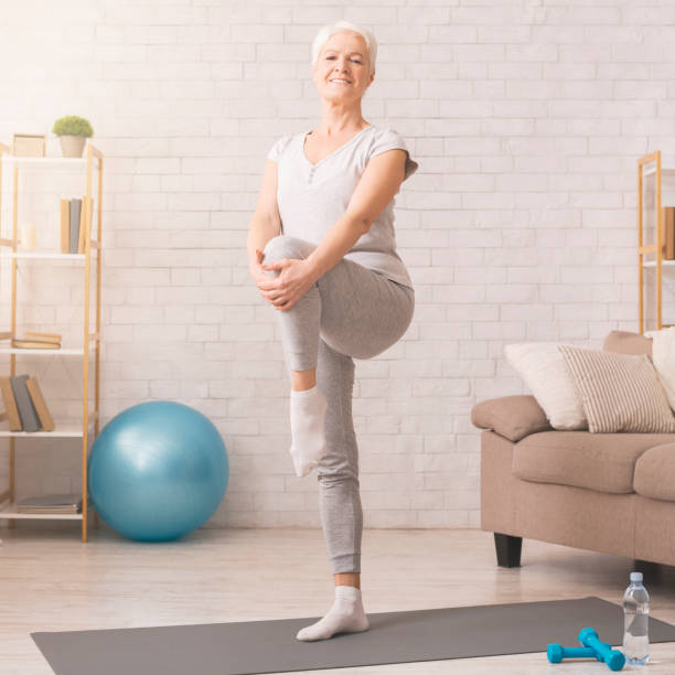 istock Cheerful senior woman exercising at home, free space 1210750102