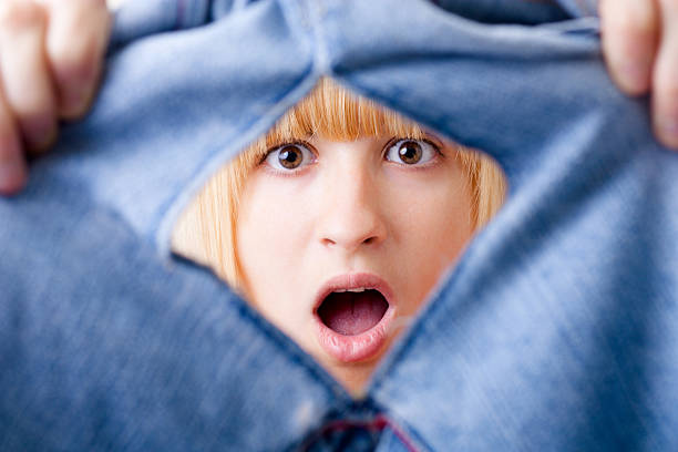Shocked Woman with Torn Jeans Shocked Woman with Torn Jeans hole in pants stock pictures, royalty-free photos & images