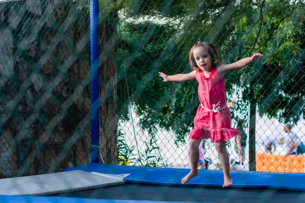 istock Happy girl jumping on trampoline 1210754078