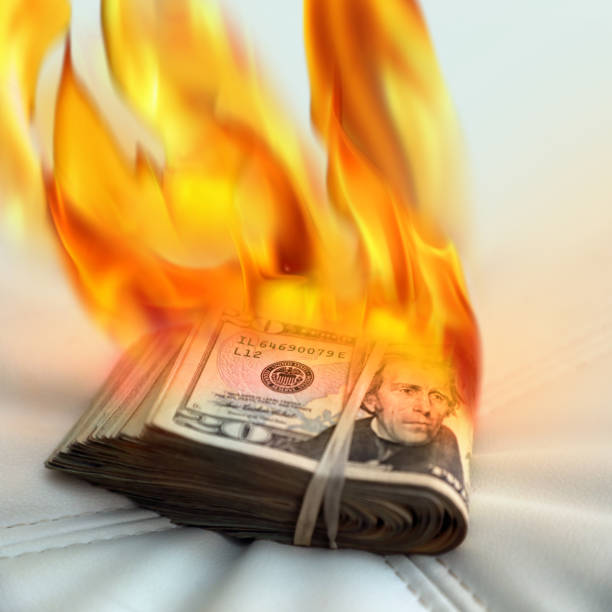 istock burning rubber banded American twenty dollar bills pile 1210754671