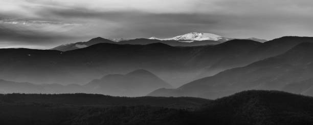 istock Wide angle panoramic shot of mountains with snow on high peaks 1210754903