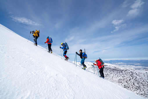 Climbers are walking to the peak of the high altitude mountain in winter in Turkey ,photo is taken during a climbing expedition.