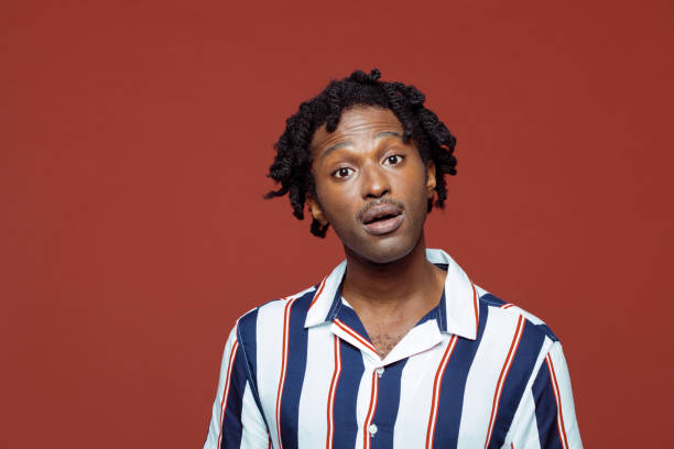 istock Surprised young man in retro style striped shirt 1210755373