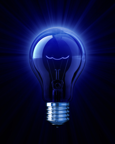 Hand holding lightbulb with bright light in dark background. Glowing light bulb for idea and innovation concept.