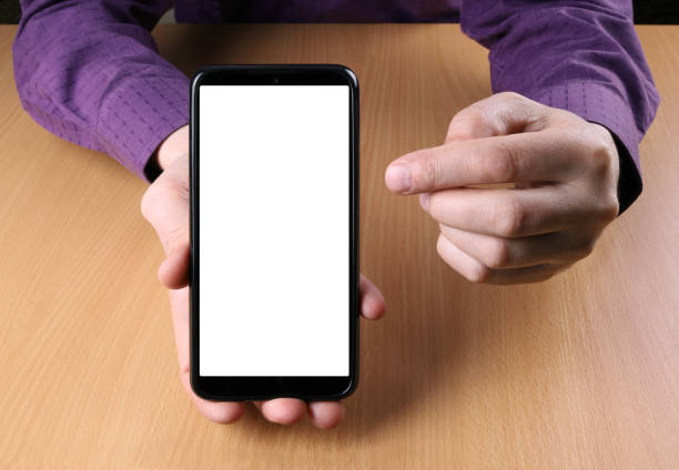 istock Man holds a smartphone and shows the viewer on the screen 1210756429