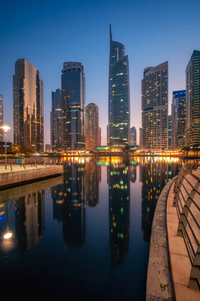 Amazing architecture parallel buildings. Cloudy night sky. Luxury travel inspiration. Dubai Jumeirah Lake Towers. Amazing architecture parallel buildings. Cloudy night sky. Luxury travel inspiration. Dubai Jumeirah Lake Towers. jumeirah stock pictures, royalty-free photos & images