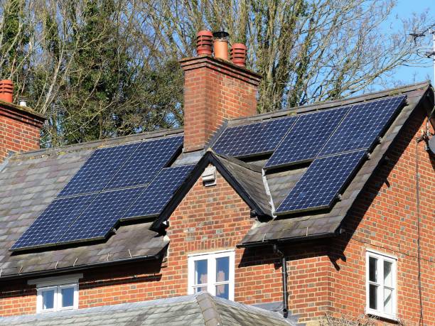 Solar panels on house rooftop used to generate electricity This photo was taken in Chorleywood, Hertfordshire, England, UK climate crisis photos stock pictures, royalty-free photos & images