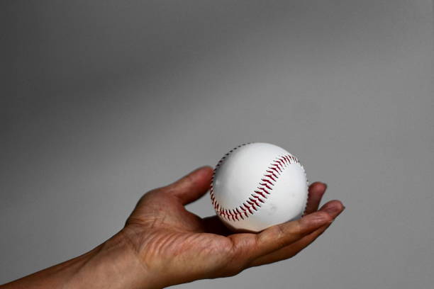 istock A hand grasping a baseball in various poses 1210758124
