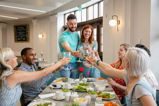 istock Friends congratulating couple with toast at dinner 1210760851