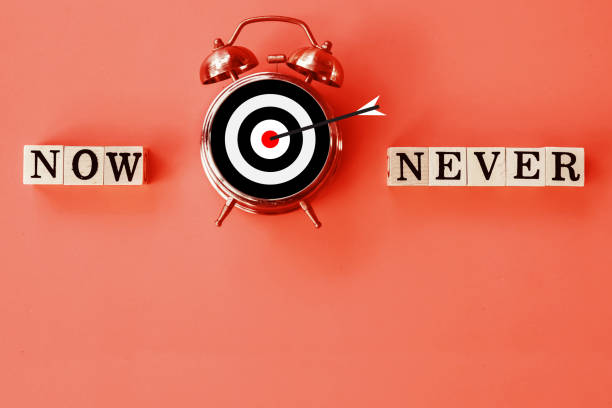 now or never concept with target sign on clock face with copy space background