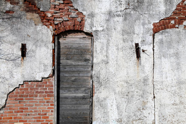 vintage stucco brick wall boarded wooden arched window