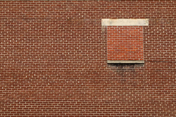 window in the wall of an old house, with a bricked-in opening and a place for text