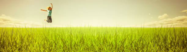 Woman jumps in a meadow