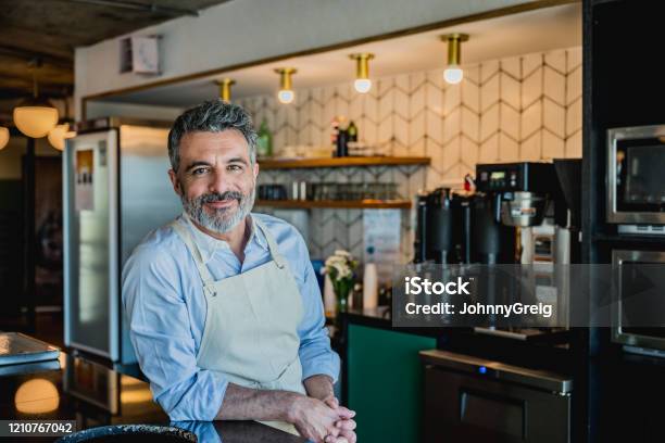 Smiling Male Barista Ready To Prepare Drink In Coffee Bar Stock Photo - Download Image Now