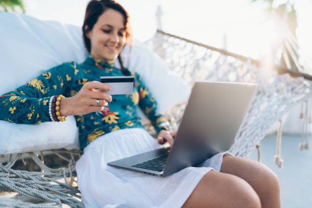 istock Girl in hammock shopping online 1210769768