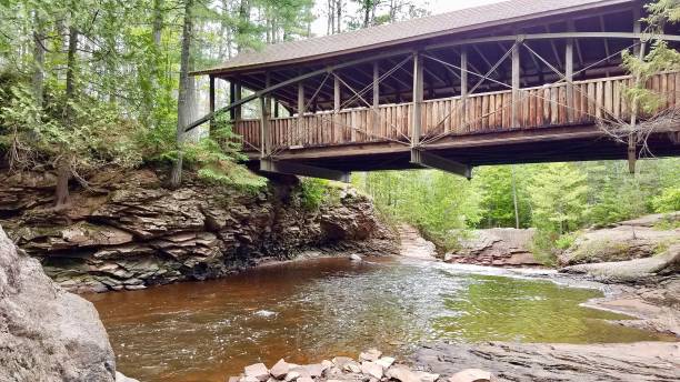 istock Wooden covered bridge over a Wisconsin river 1210770891