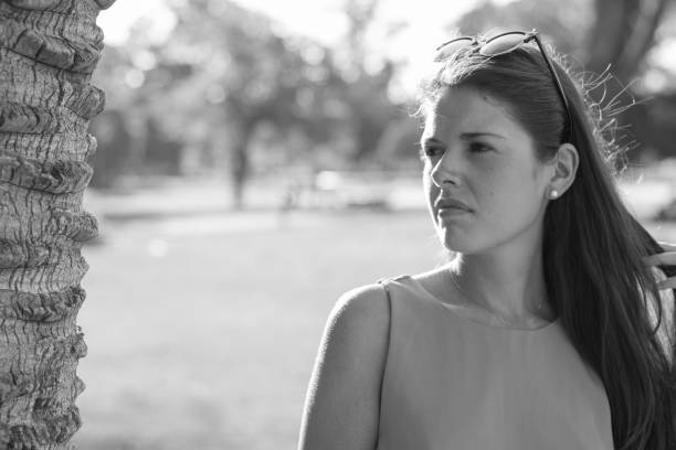 Woman portrait outdoors with green shirt in summer at the park