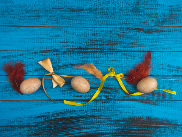 istock Easter eggs on rustic wooden background, trendy blue surface 1210772114