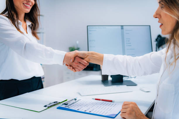 istock Handshake After Signing Health Insurance Form 1210772622