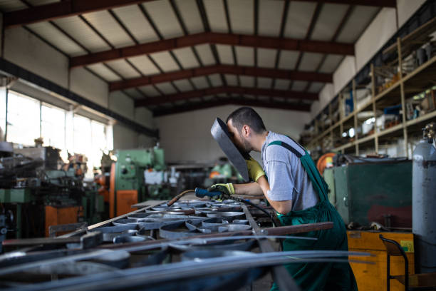 istock Manual worker welding at metal factory 1210773488