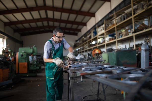 istock Manual worker grinding at metal factory 1210773752