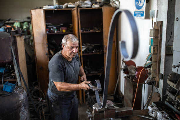 istock Hardworking man at metal factory 1210773811