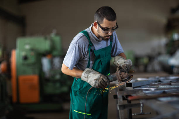 istock Manual worker grinding at metal factory 1210773817