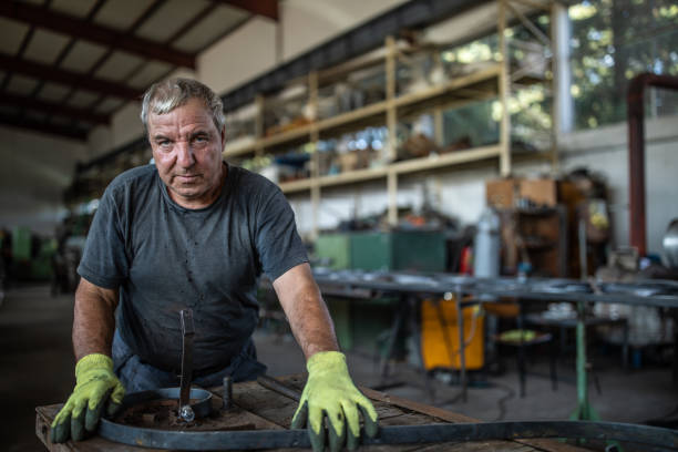 istock Industrial worker at metal factory 1210774471