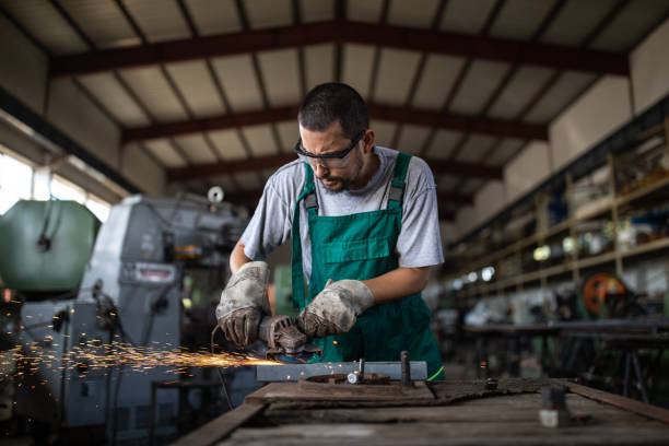 istock Manual worker grinding at metal factory 1210774484