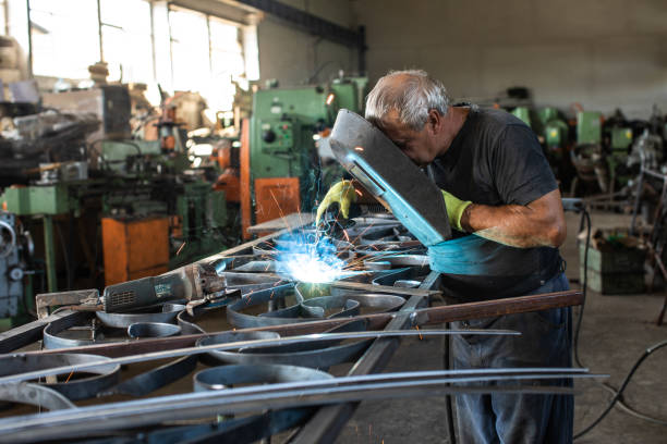istock Manual worker welding at metal factory 1210774500