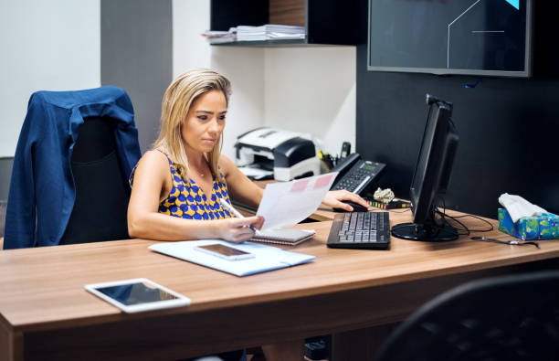 istock Reviewing reports at her desk 1210775269
