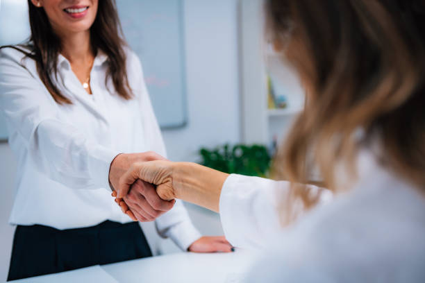 istock Handshake After Signing Health Insurance Form 1210775270